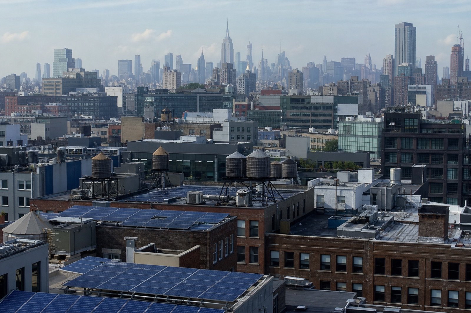 New York City commercial rooftops with solar arrays, illustrating SIR interconnection cost rules.