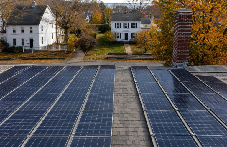 New England colonial rooftop solar with a clear firefighter access pathway between modules.