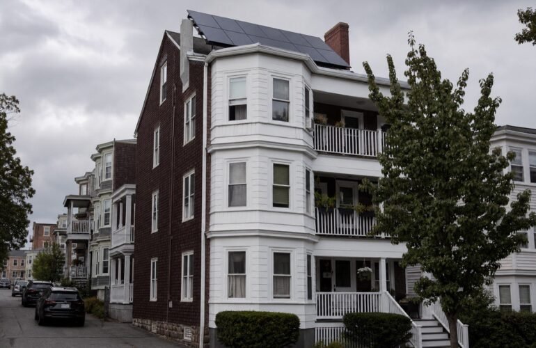 Massachusetts rooftop solar on a triple-decker house for a solar permit requirements guide.