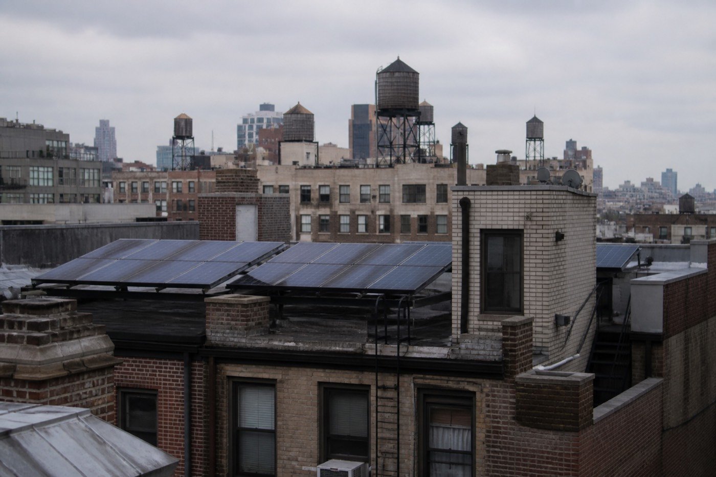New York City brick rooftop solar array for an NY-Sun installer guide.